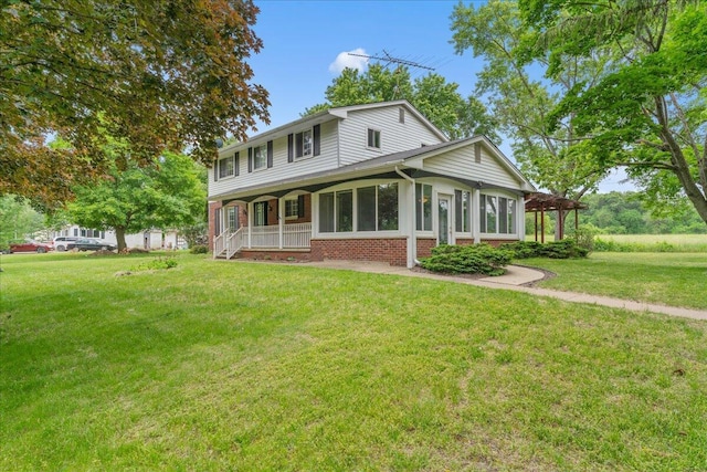 360 Wood Creek Dr, Howell, MI 48843 - view of front of home with brick siding, a front lawn, and covered porch