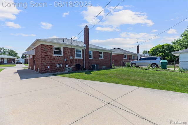 19045 Morningside Ave, Eastpointe, MI 48021 - back of property featuring brick siding, a chimney, and concrete driveway
