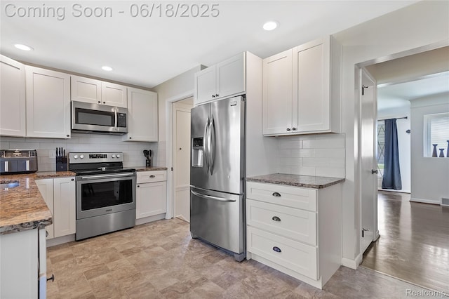 19045 Morningside Ave, Eastpointe, MI 48021 - kitchen featuring appliances with stainless steel finishes, tasteful backsplash, white cabinets, light stone countertops, and recessed lighting
