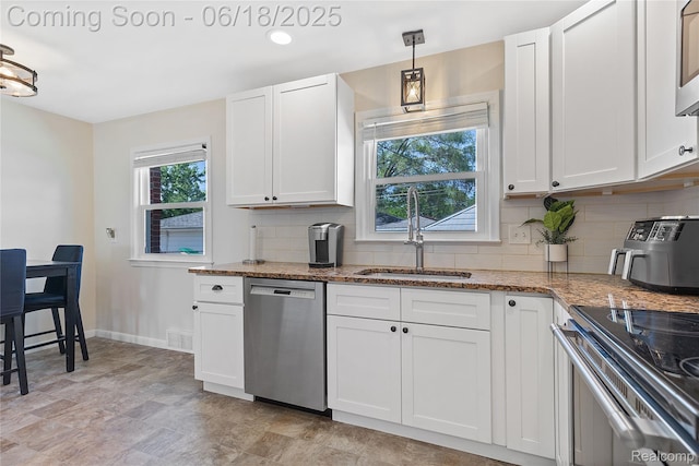 19045 Morningside Ave, Eastpointe, MI 48021 - kitchen with stainless steel appliances, decorative backsplash, light stone countertops, and white cabinets