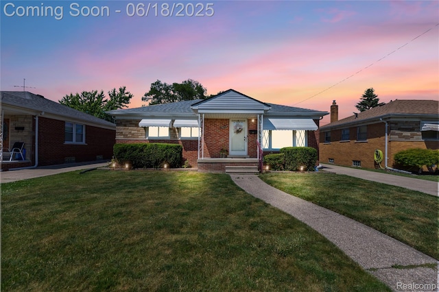 19045 Morningside Ave, Eastpointe, MI 48021 - view of front of house featuring brick siding and a front lawn