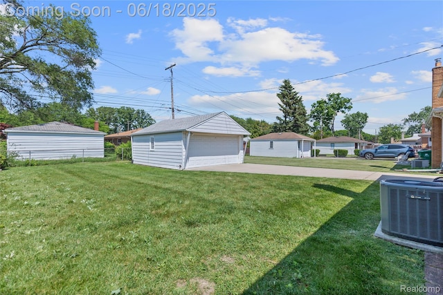 19045 Morningside Ave, Eastpointe, MI 48021 - view of green lawn featuring a garage and an outbuilding