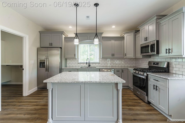23013 Helen, Southfield, MI 48033 - kitchen featuring stainless steel appliances, gray cabinetry, a kitchen island, tasteful backsplash, and dark wood finished floors