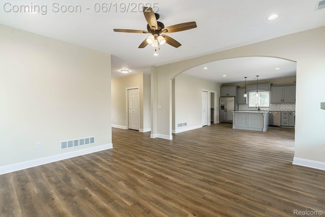 23013 Helen, Southfield, MI 48033 - unfurnished living room featuring arched walkways, dark wood-style floors, ceiling fan, and recessed lighting