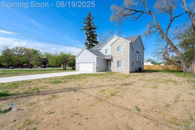 23013 Helen, Southfield, MI 48033 - view of home's exterior featuring stone siding, concrete driveway, and an attached garage
