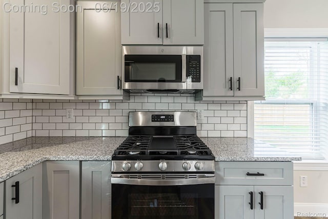 23013 Helen, Southfield, MI 48033 - kitchen featuring appliances with stainless steel finishes, gray cabinets, backsplash, and plenty of natural light