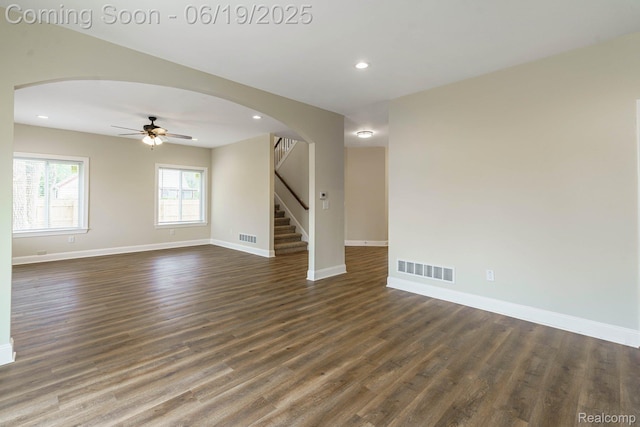 23013 Helen, Southfield, MI 48033 - empty room with arched walkways, dark wood-style floors, a ceiling fan, stairs, and recessed lighting