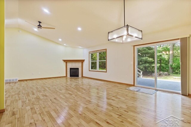 878 S Crooked Tree Ln, Midland, MI 48640 - unfurnished living room with light wood-type flooring, vaulted ceiling, a fireplace, ceiling fan, and recessed lighting