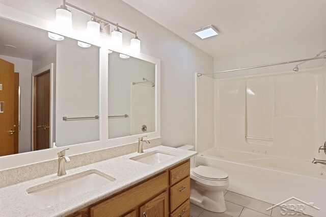 878 S Crooked Tree Ln, Midland, MI 48640 - full bath with double vanity, shower / tub combination, and tile patterned flooring