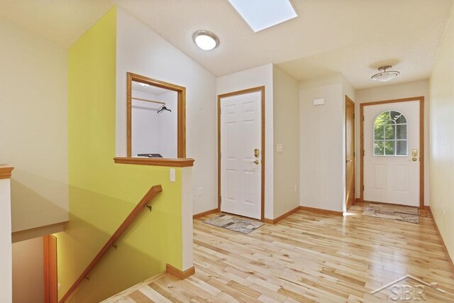 878 S Crooked Tree Ln, Midland, MI 48640 - entryway with light wood-type flooring and a skylight
