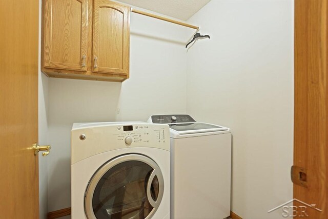 878 S Crooked Tree Ln, Midland, MI 48640 - laundry area featuring washing machine and clothes dryer and cabinet space