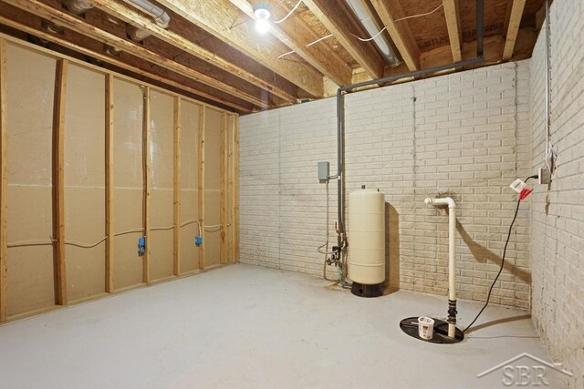 878 S Crooked Tree Ln, Midland, MI 48640 - unfinished basement featuring a water pressure tank and brick wall
