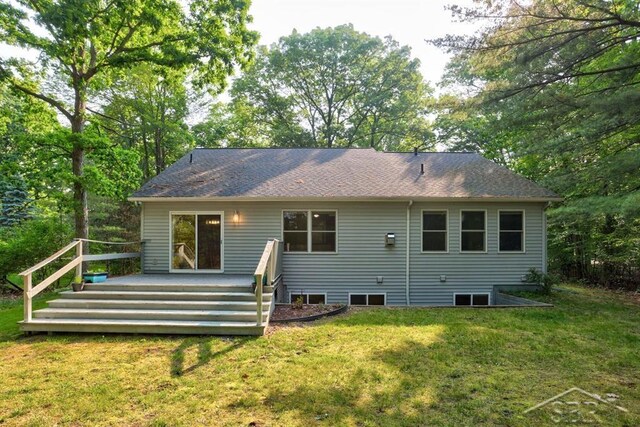 878 S Crooked Tree Ln, Midland, MI 48640 - rear view of property featuring a yard, a wooden deck, and a shingled roof