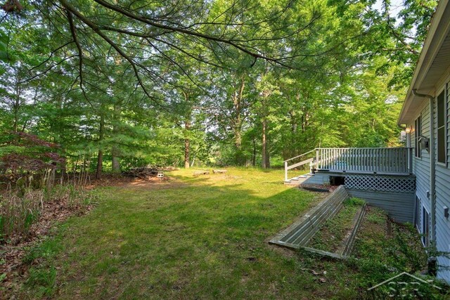 878 S Crooked Tree Ln, Midland, MI 48640 - view of green lawn with a wooden deck