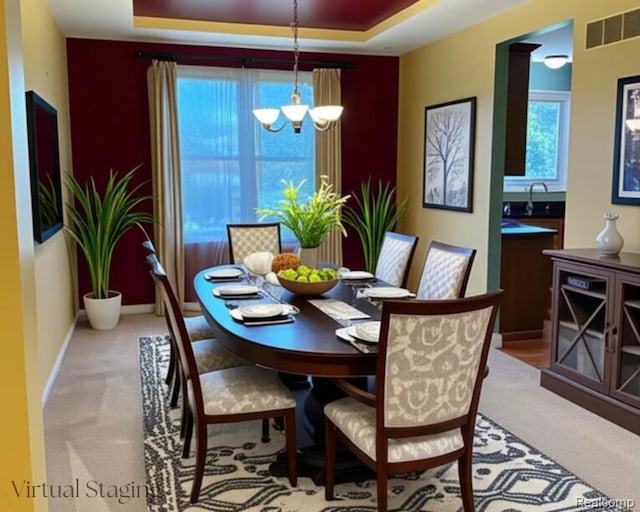 49941 Baychester Blvd, Canton, MI 48187 - carpeted dining area featuring a tray ceiling, plenty of natural light, and a chandelier