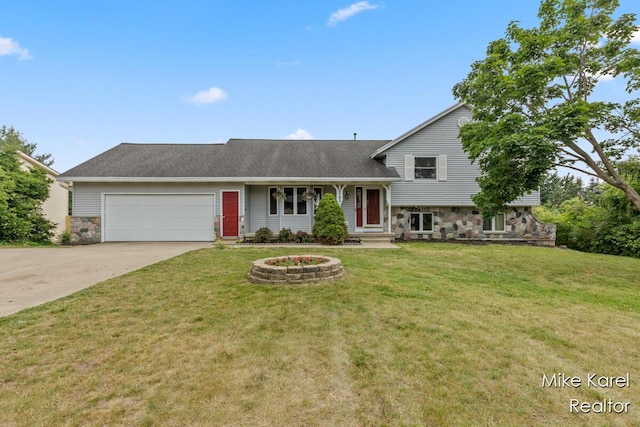 2742 Woodridge Dr, Jenison, MI 49428 - tri-level home featuring stone siding, an attached garage, driveway, a front lawn, and a shingled roof