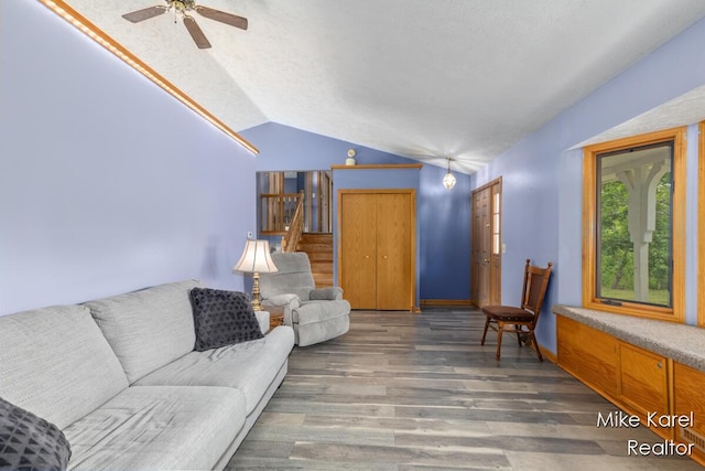2742 Woodridge Dr, Jenison, MI 49428 - living area with vaulted ceiling, wood finished floors, ceiling fan, and stairway