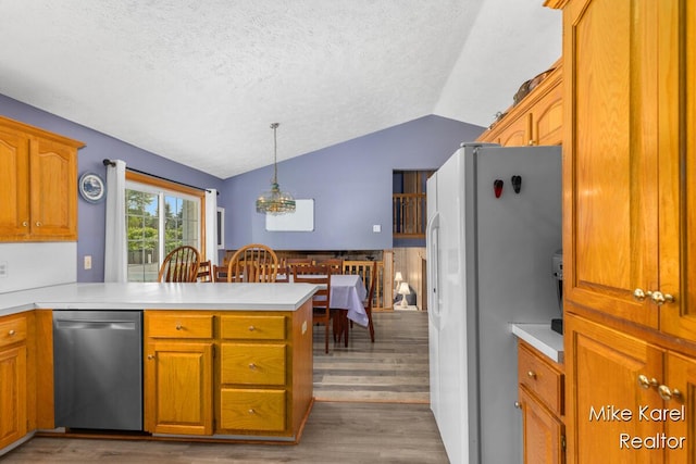 2742 Woodridge Dr, Jenison, MI 49428 - kitchen with dishwasher, freestanding refrigerator, lofted ceiling, a peninsula, and wood finished floors
