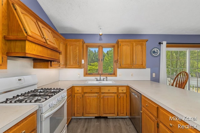 2742 Woodridge Dr, Jenison, MI 49428 - kitchen featuring white gas range, dishwasher, light countertops, wood finished floors, and a textured ceiling