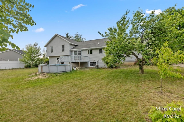 2742 Woodridge Dr, Jenison, MI 49428 - back of house featuring a deck and a lawn