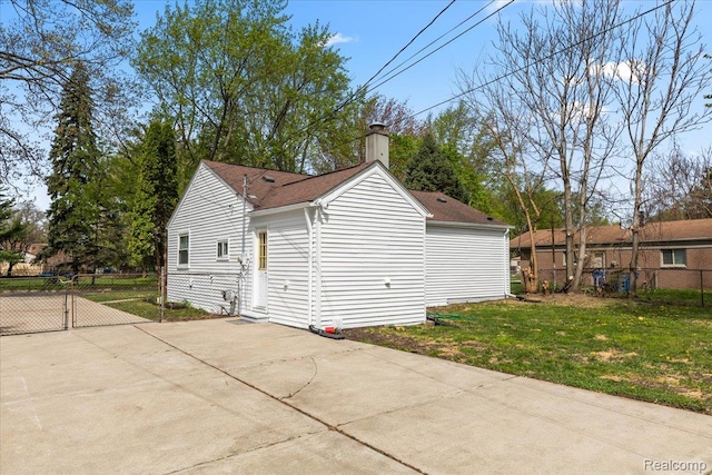 24270 Columbus Ave, Warren, MI 48089 - view of side of home featuring a shingled roof, a chimney, and a gate