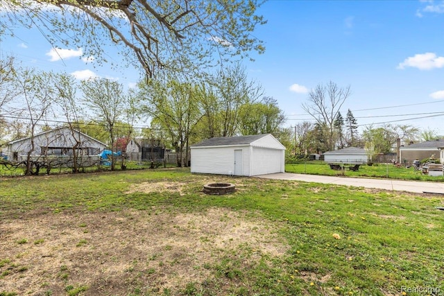 24270 Columbus Ave, Warren, MI 48089 - view of yard with an outbuilding, a detached garage, and a fire pit