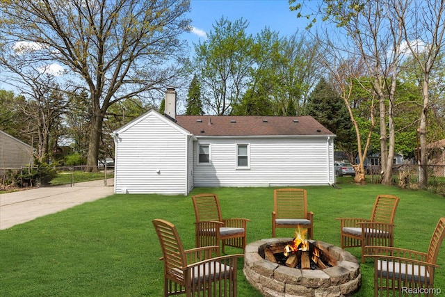 24270 Columbus Ave, Warren, MI 48089 - back of house featuring a fire pit, a chimney, and a shingled roof