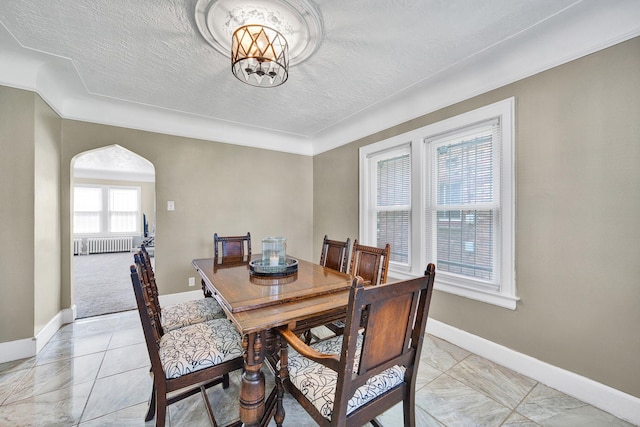14311 Forrer St, Detroit, MI 48227 - dining space with radiator heating unit, arched walkways, a textured ceiling, light tile patterned floors, and a chandelier