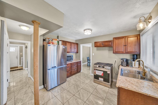 14311 Forrer St, Detroit, MI 48227 - kitchen with stainless steel appliances, light marble finish flooring, light countertops, and brown cabinets