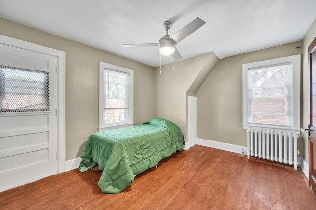 14311 Forrer St, Detroit, MI 48227 - bedroom with radiator heating unit, wood finished floors, and ceiling fan