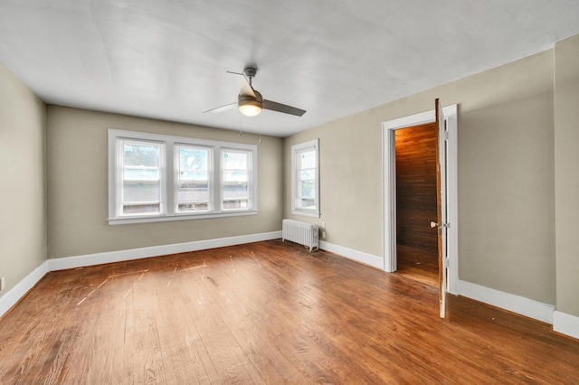 14311 Forrer St, Detroit, MI 48227 - spare room featuring radiator heating unit, a ceiling fan, and wood finished floors