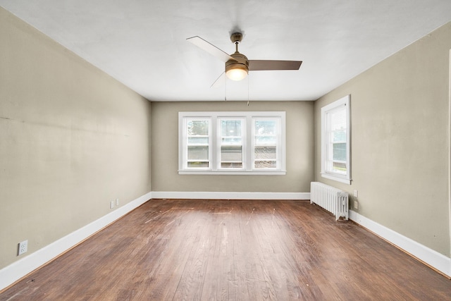 14311 Forrer St, Detroit, MI 48227 - empty room with radiator heating unit, ceiling fan, and wood finished floors
