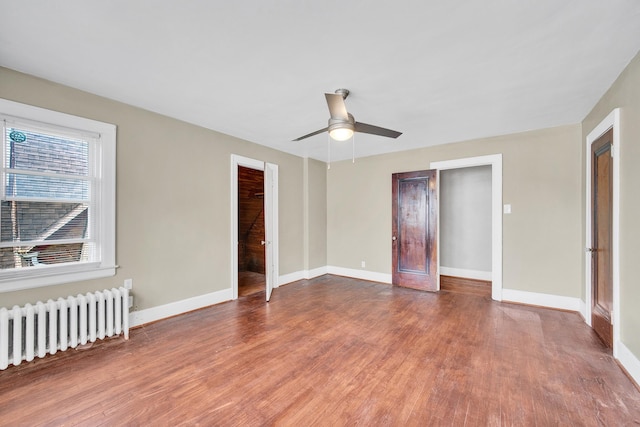 14311 Forrer St, Detroit, MI 48227 - unfurnished bedroom featuring radiator, wood finished floors, and ceiling fan