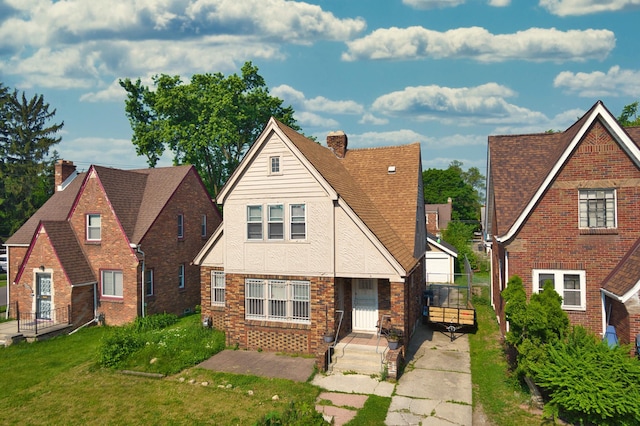 14311 Forrer St, Detroit, MI 48227 - english style home with a chimney, a front lawn, brick siding, and stucco siding