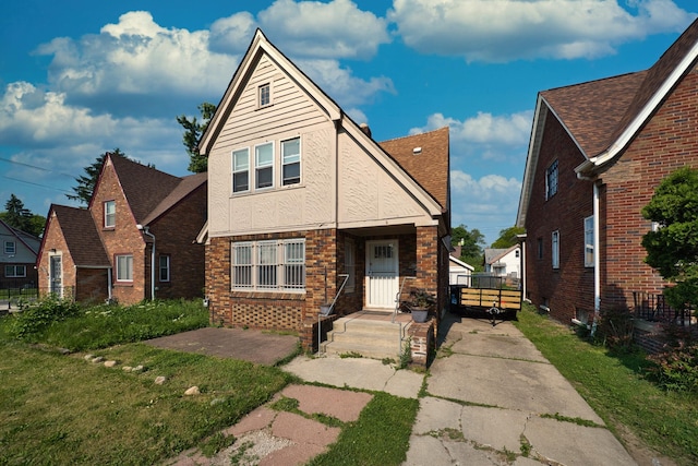 14311 Forrer St, Detroit, MI 48227 - view of front of house featuring stucco siding, roof with shingles, and brick siding