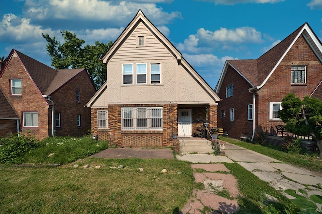 14311 Forrer St, Detroit, MI 48227 - view of front of house featuring stucco siding, a front yard, and brick siding
