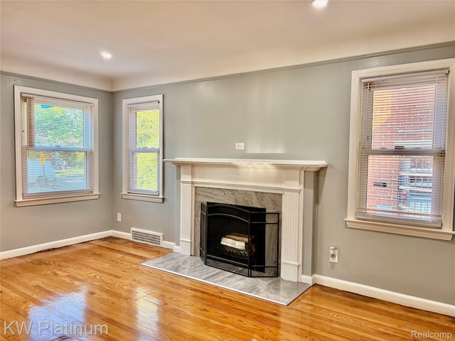 16054 Carlisle St, Detroit, MI 48205 - unfurnished living room with wood finished floors and a fireplace