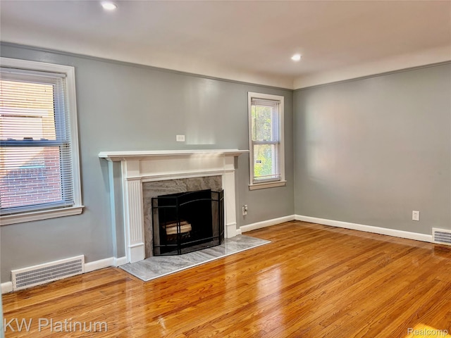 16054 Carlisle St, Detroit, MI 48205 - unfurnished living room featuring a fireplace, wood finished floors, and recessed lighting