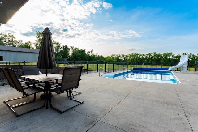 6360 Ray Rd, Swartz Creek, MI 48473 - view of swimming pool with a water slide, a patio area, and outdoor dining space
