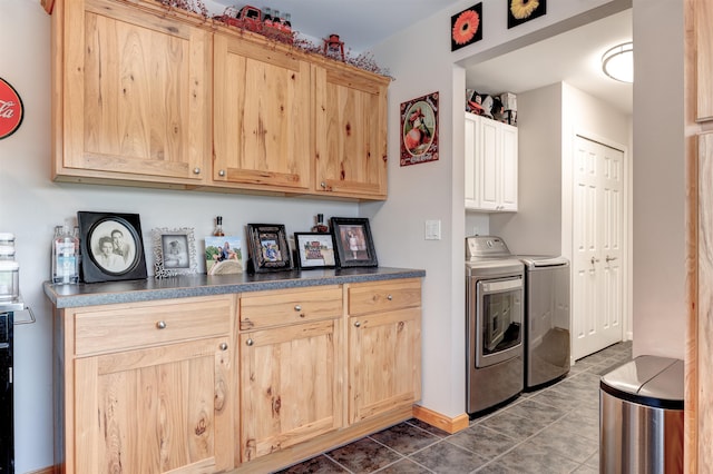 6360 Ray Rd, Swartz Creek, MI 48473 - washroom featuring cabinet space, washing machine and clothes dryer, and dark tile patterned flooring
