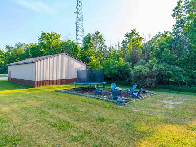 6360 Ray Rd, Swartz Creek, MI 48473 - view of grassy yard featuring a trampoline