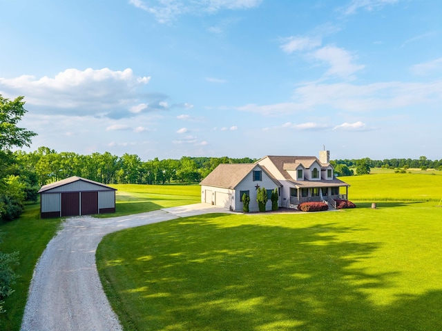 6360 Ray Rd, Swartz Creek, MI 48473 - view of front of house featuring concrete driveway, a chimney, a front yard, a garage, and a pole building