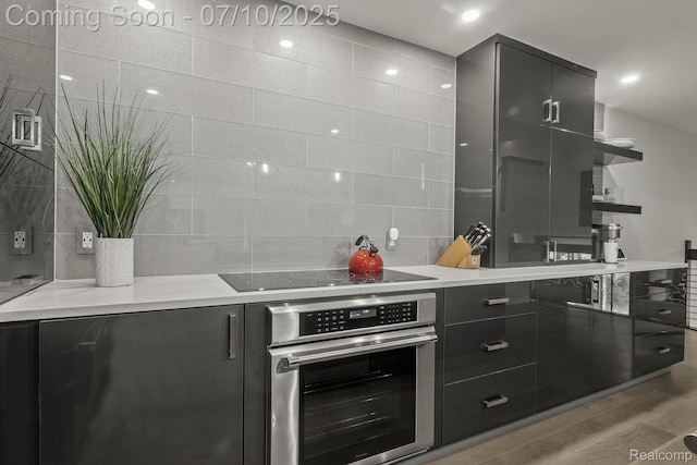 418 E 5th St Unit 2, Royal Oak, MI 48067 - kitchen featuring oven, black electric stovetop, light wood-style flooring, open shelves, and modern cabinets