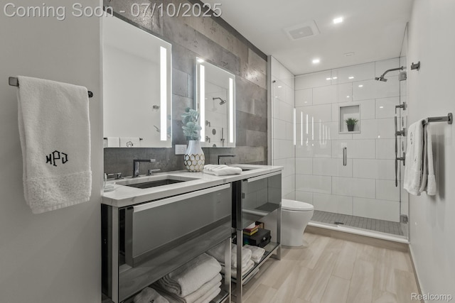 418 E 5th St Unit 2, Royal Oak, MI 48067 - bathroom featuring a stall shower, vanity, backsplash, and recessed lighting