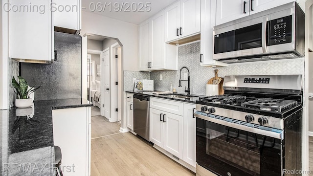 24520 Laetham Ave, Saint Clair Shores, MI 48021 - kitchen with stainless steel appliances, light wood-type flooring, and white cabinets