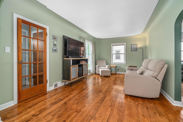 2646 Forest Grove Ave SW, Wyoming, MI 49519 - living room featuring arched walkways and wood finished floors