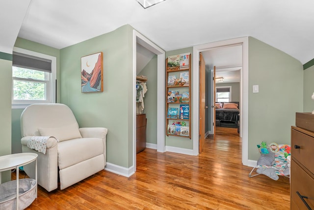 2646 Forest Grove Ave SW, Wyoming, MI 49519 - living area featuring light wood-style flooring, plenty of natural light, and vaulted ceiling
