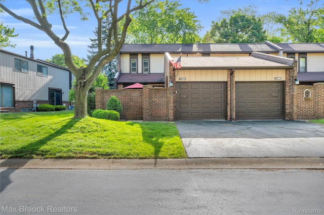 1169 Kirts Blvd Unit 12, Troy, MI 48084 - view of front facade with brick siding, concrete driveway, a garage, and a front yard