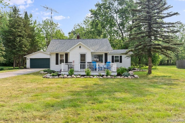 316 N Seymour Rd, Flushing, MI 48433 - view of front of house featuring a shingled roof, a garage, a front lawn, an outbuilding, and a porch