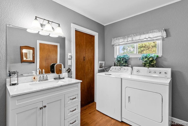 316 N Seymour Rd, Flushing, MI 48433 - laundry room with independent washer and dryer, light wood-style floors, crown molding, and a textured wall